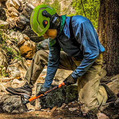 Blaze tool by Backslope Tools, orange and black handle, used on rocky outdoor terrain on Tampa Home & Garden Store