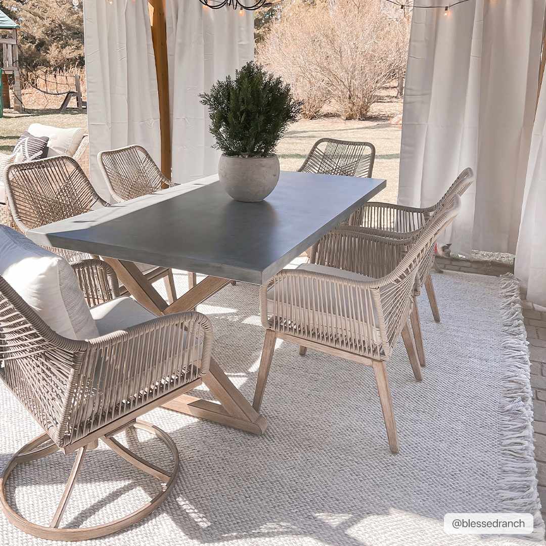 Stenhousemuir Rug by Boutique Rugs; beige rug under gray dining table with wicker chairs on patio on Tampa Home & Garden Store