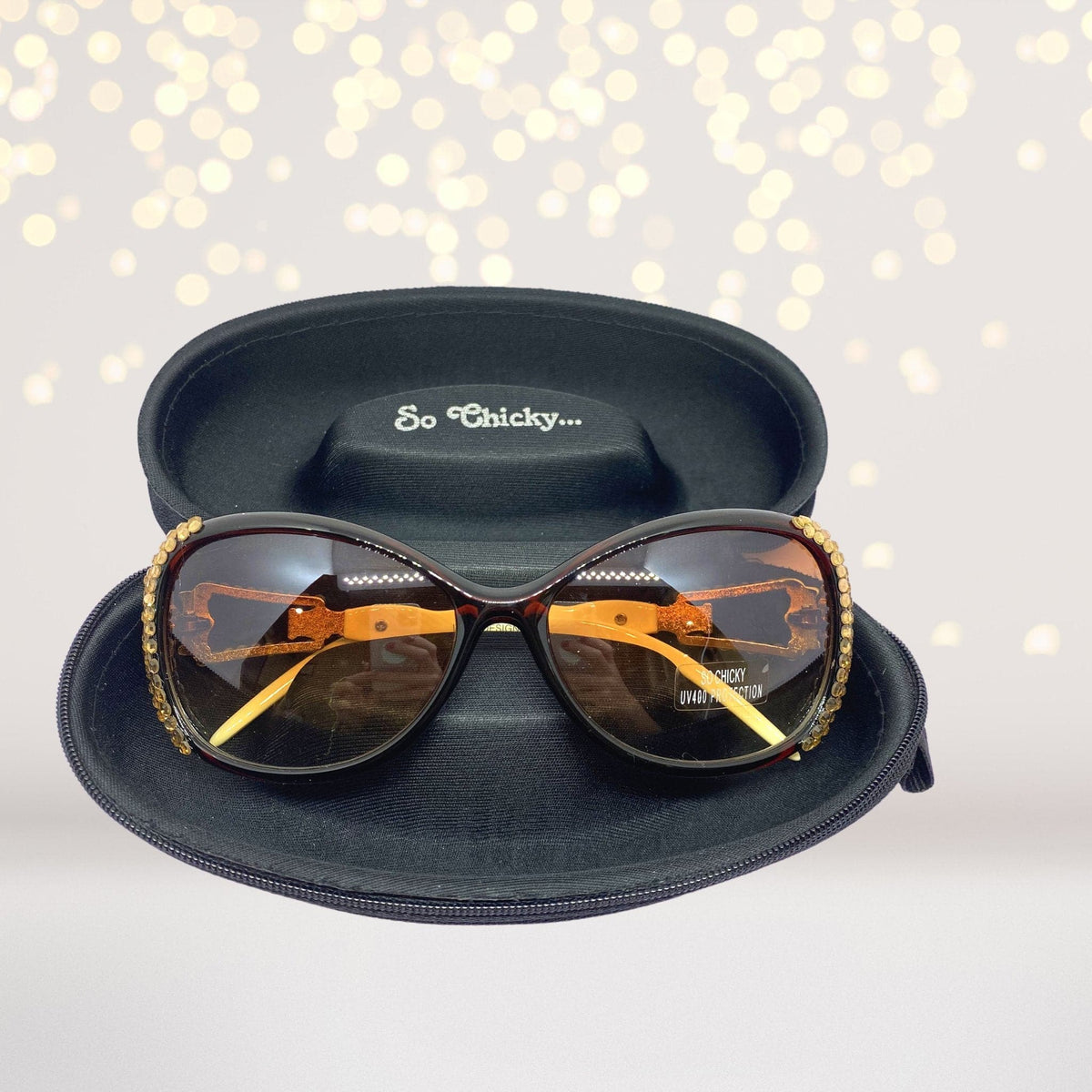 Bling Stone Sunglasses with gold beaded rim and amber lenses in a black case on Tampa Home & Garden Store