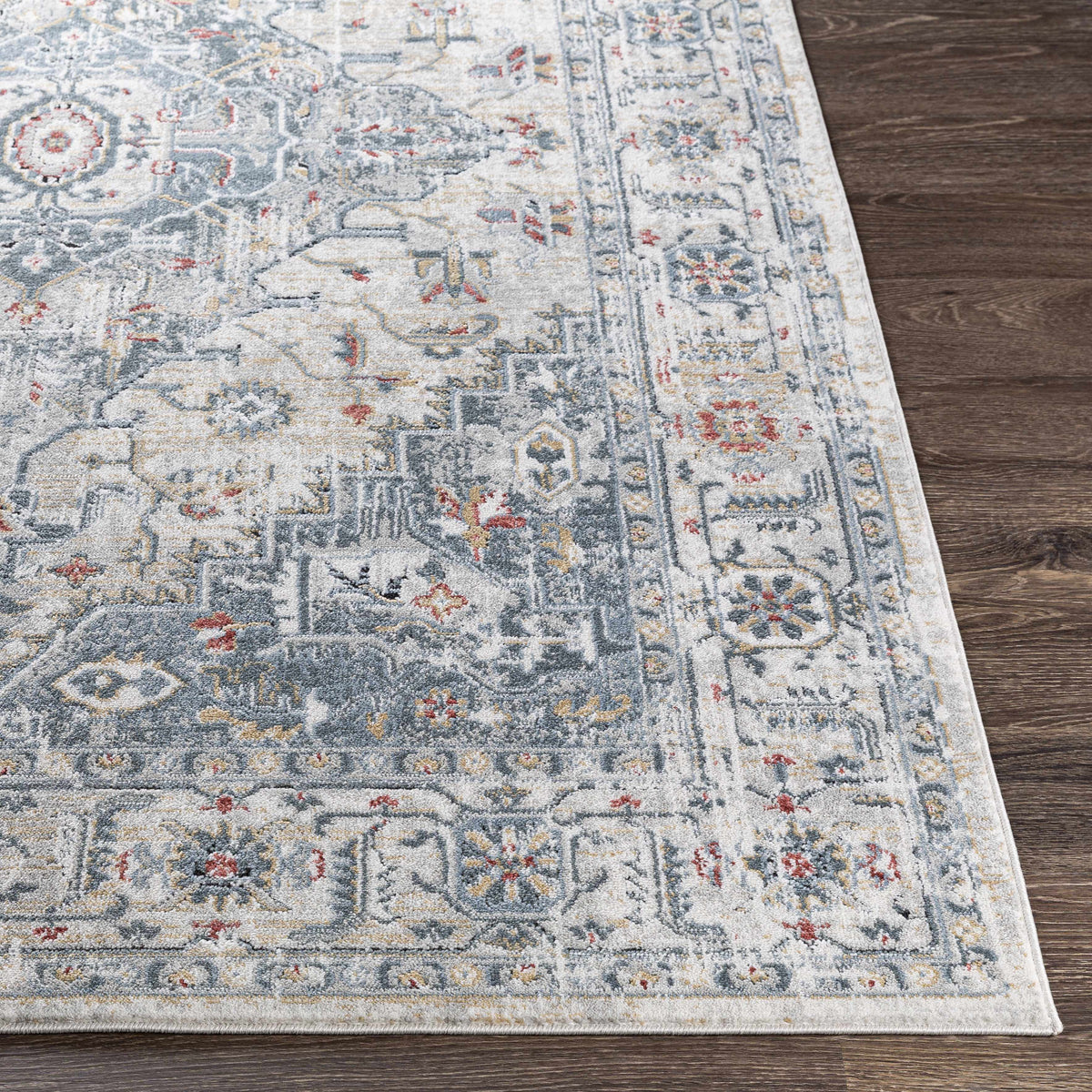 Billings Area Rug from Boutique Rugs in blue ivory ornate border design on wood floor on Tampa Home & Garden Store