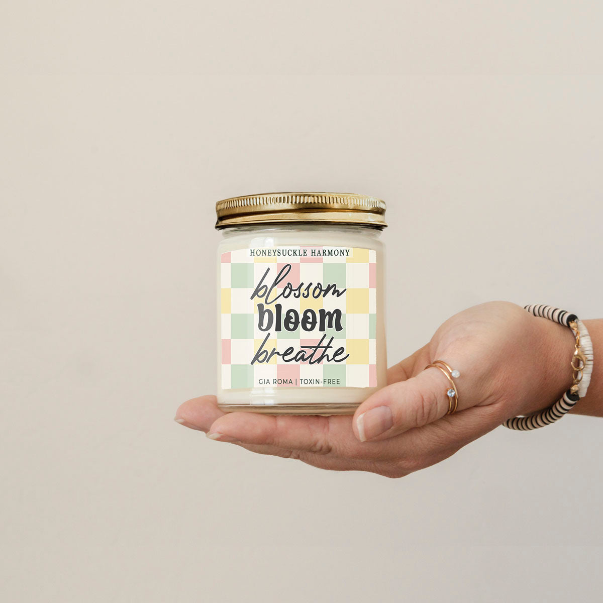 Candle Honeysuckle Harmony by Gia Roma in a glass jar with a gold lid and check label on Tampa Home & Garden Store