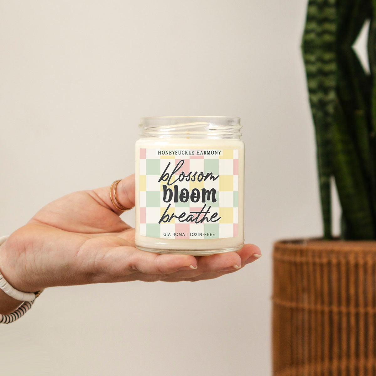 Honeysuckle Harmony Candle Gia Roma in a clear glass jar with pastel plaid label and white wax held on Tampa Home & Garden Store