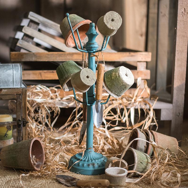 Blue RusticReach Cup Holder Planter Holder on teal metal stand with multiple pots on Tampa Home & Garden Store