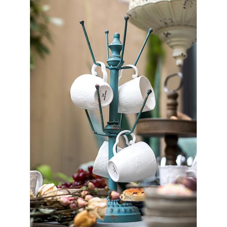 Blue Cup Holder Planter Holder on teal metal mug tree with white mugs on Tampa Home & Garden Store