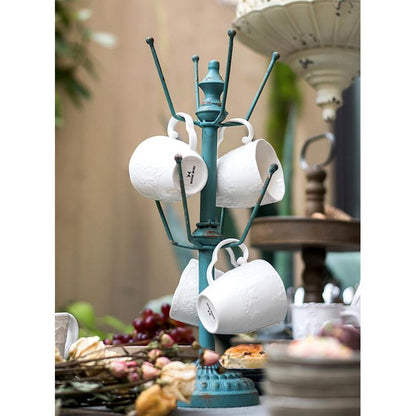 Blue Cup Holder Planter Holder on teal metal mug tree with white mugs on Tampa Home & Garden Store