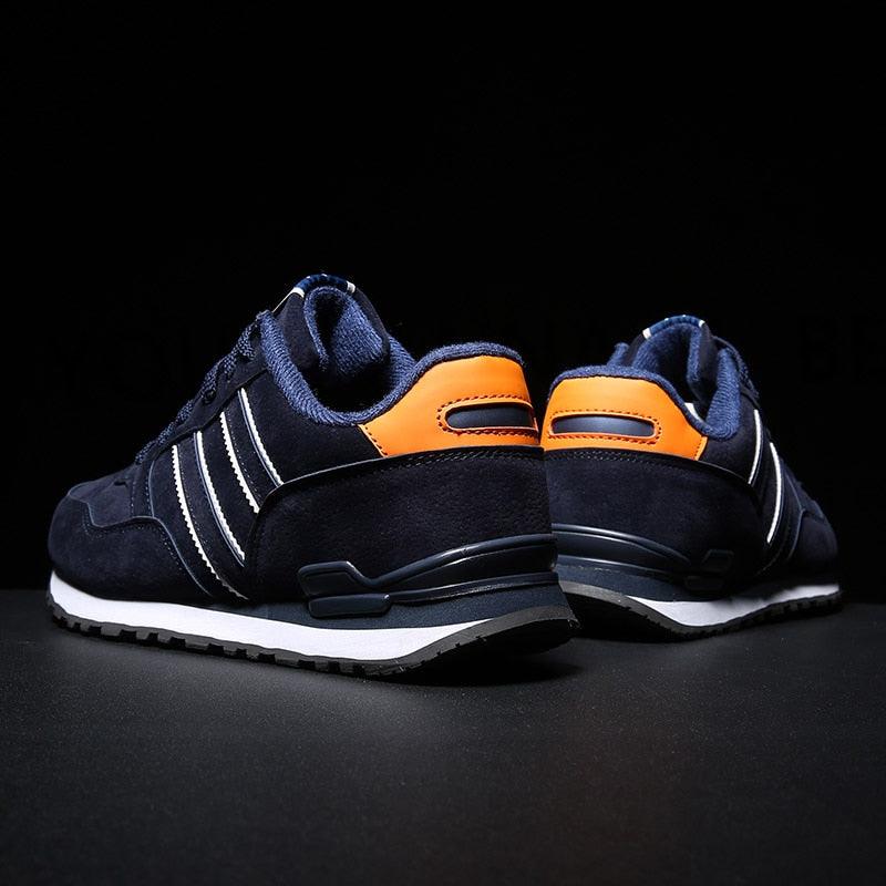 Stevvex blue men's casual sneakers pair with white stripes and orange heel patch on Tampa Home & Garden Store