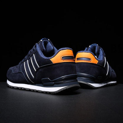 Stevvex blue men's casual sneakers pair with white stripes and orange heel patch on Tampa Home & Garden Store