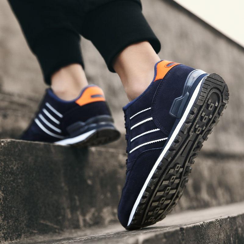 Blue Stevvex casual sneakers with white stripes and orange heel tab and rugged outsole on Tampa Home & Garden Store