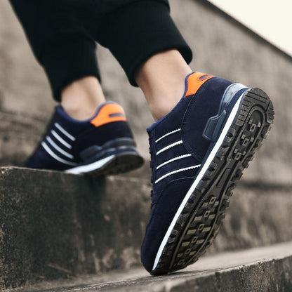 Blue Stevvex casual sneakers with white stripes and orange heel tab and rugged outsole on Tampa Home & Garden Store