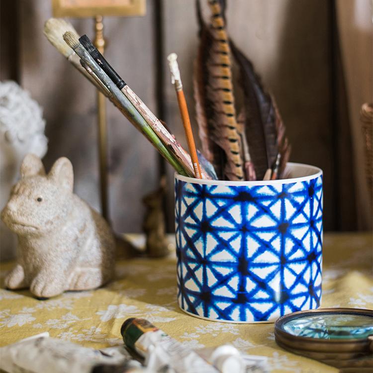 Ceramic vase planter by RusticReach with a blue geometric lattice pattern holding paintbrushes on Tampa Home & Garden Store