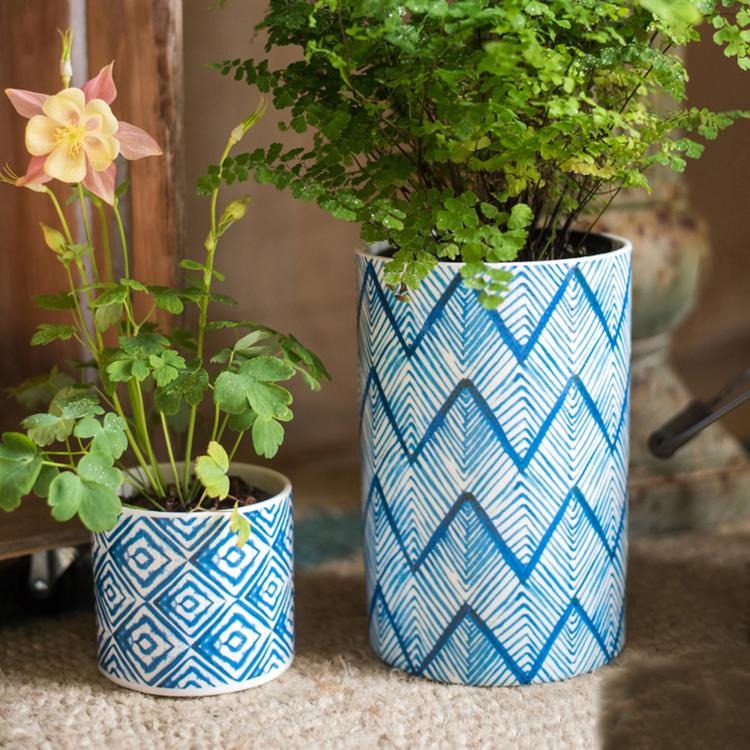 Two RusticReach blue print ceramic vase planters with geometric blue patterns holding greenery on Tampa Home & Garden Store