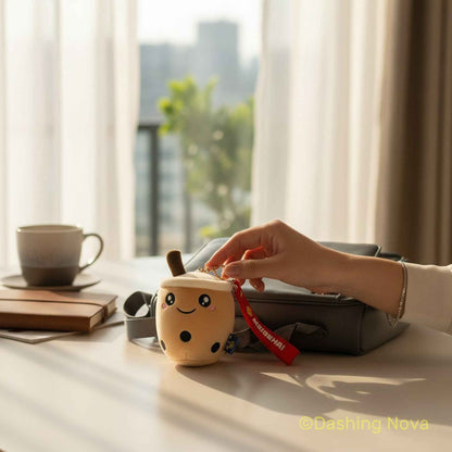 Shaketea two beige fabric boba cup keychains with cute faces and red straps on Tampa Home & Garden Store
