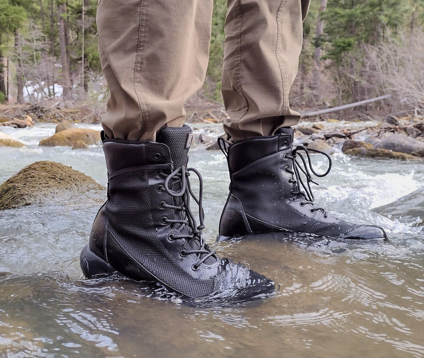 PCT 8 Boot pair, black leather with mesh panels, lace-up outdoor boots on rugged terrain on Tampa Home & Garden Store