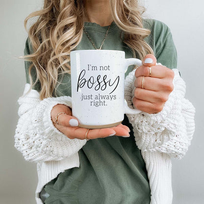 Bossy 16oz Gia Roma coffee mug, white ceramic with black script, held by a person in a green top on Tampa Home & Garden Store