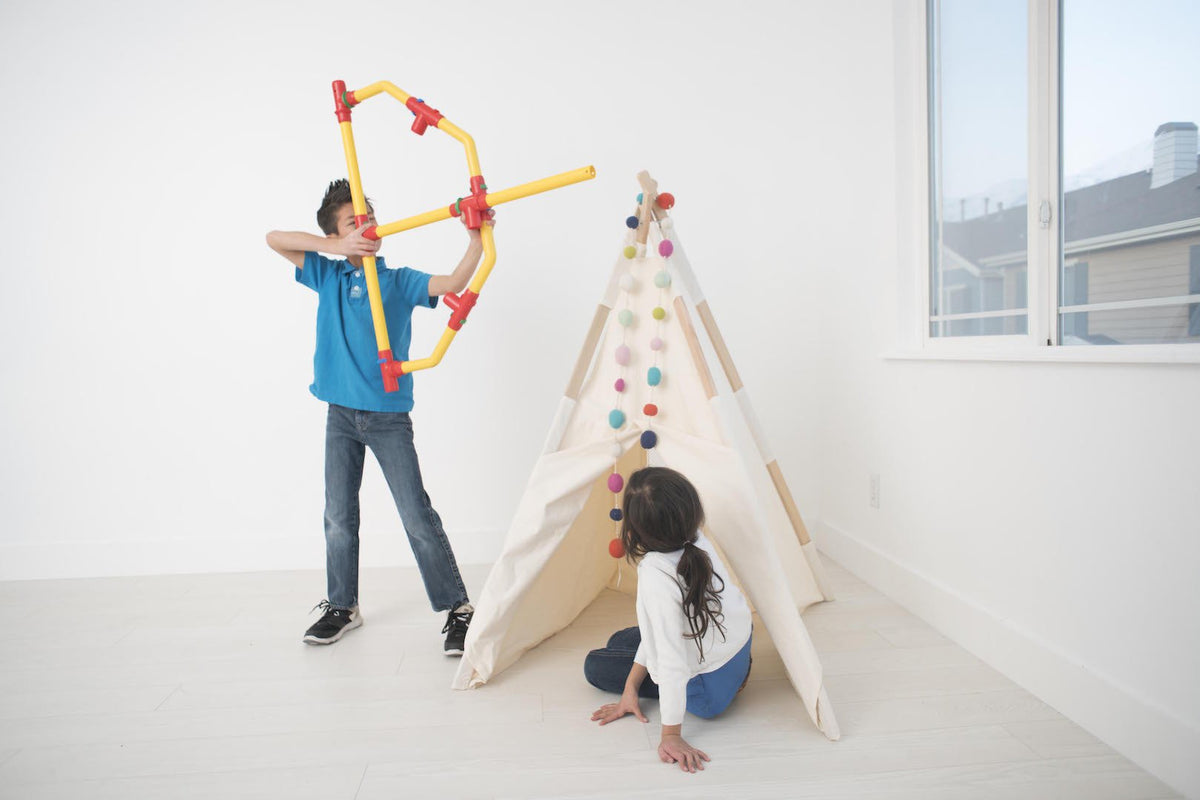 TubeLox Deluxe Set STEM toy; yellow tubes with red connectors form a frame beside fabric teepee on Tampa Home & Garden Store
