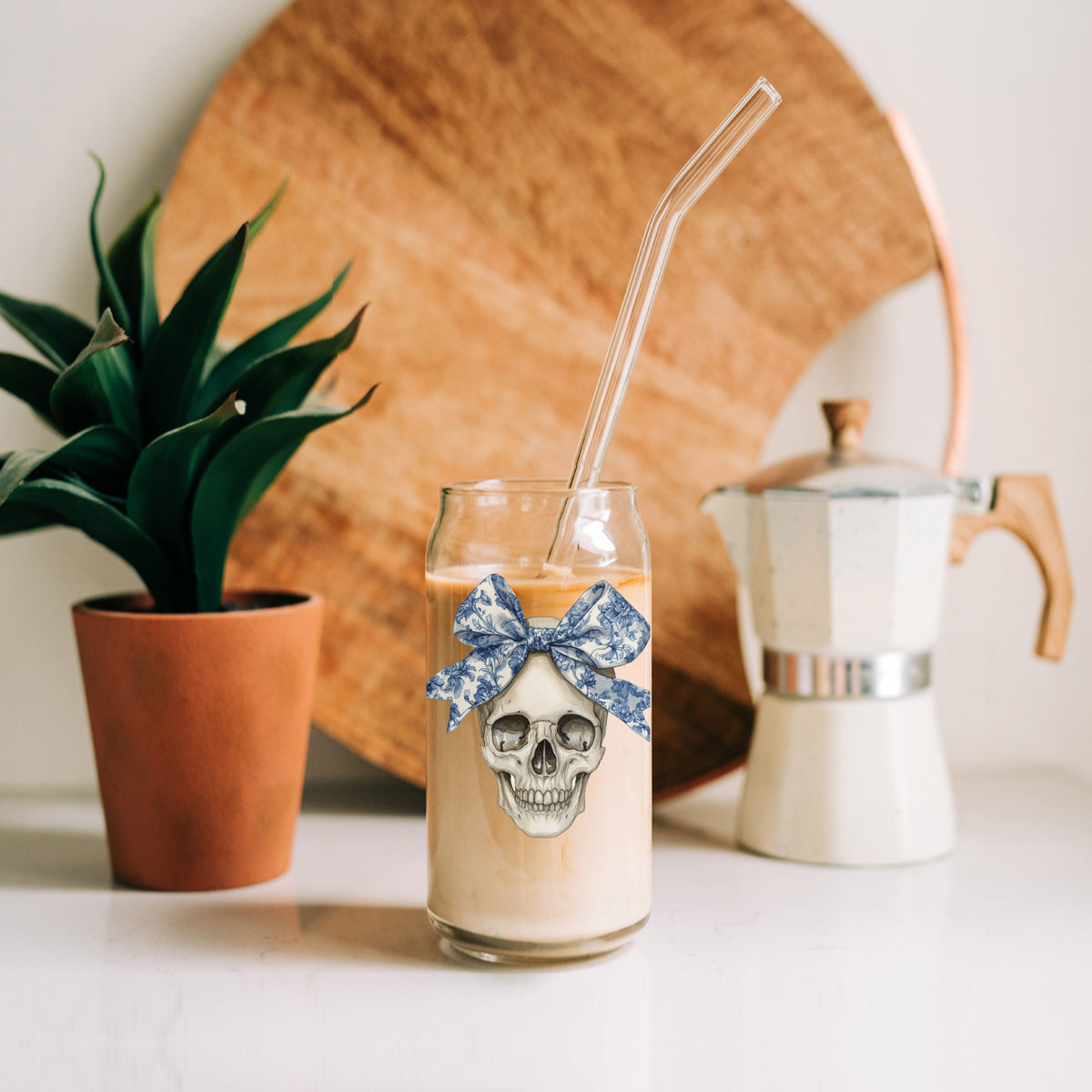 Bow Skull 20oz travel mug with transparent glass and blue bow skull graphic, clear straw on Tampa Home & Garden Store