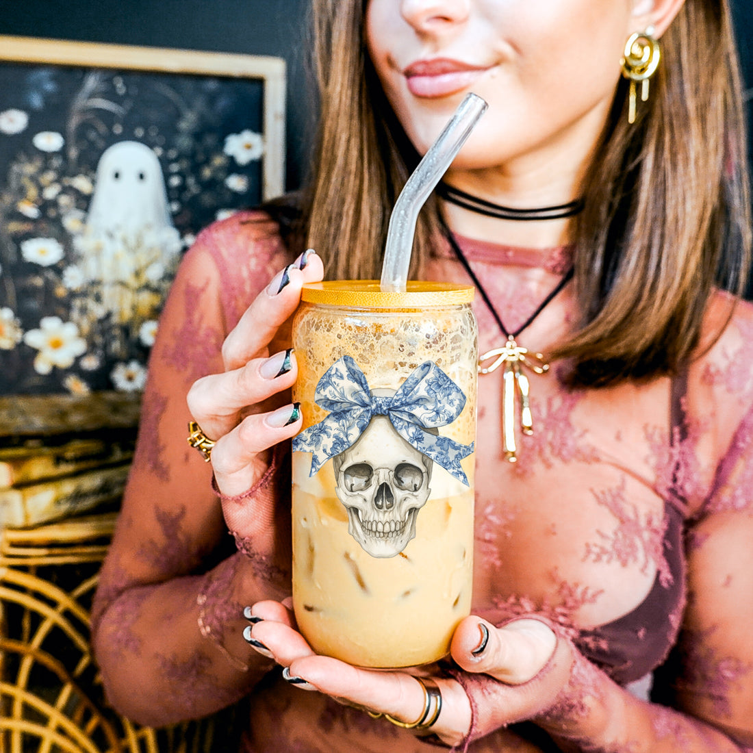 Bow Skull 20oz travel mug with iced coffee, yellow lid, straw, skull graphic and blue bow on Tampa Home & Garden Store