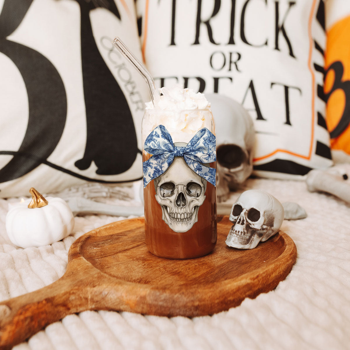 Bow Skull 20oz travel mug with skull artwork and blue bow plus whipped cream topping and clear straw on Tampa Home & Garden Store