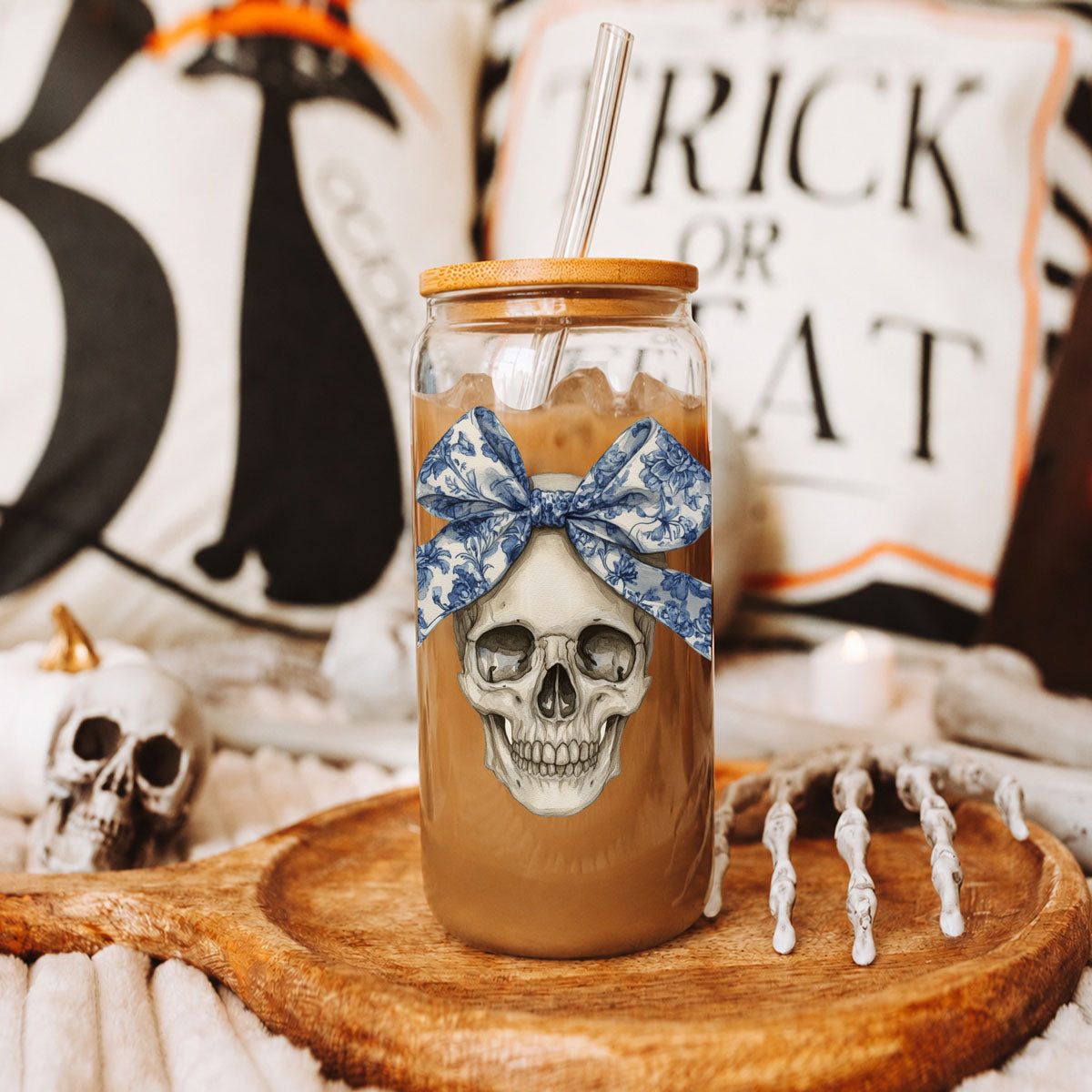 Bow Skull 20oz travel mug with blue bow skull design, glass bottle with wooden lid and straw on Tampa Home & Garden Store