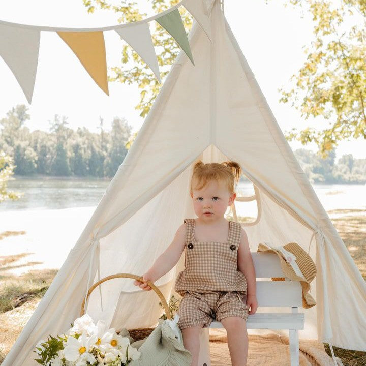 Tiny Land Teepee Tent for Kids with Mat white indoor play tent with floor mat; toddler in beige gingham sits inside under bunting by a lake on Tampa Home & Garden Store