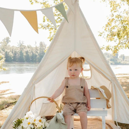 Tiny Land Teepee Tent for Kids with Mat white indoor play tent with floor mat; toddler in beige gingham sits inside under bunting by a lake on Tampa Home & Garden Store