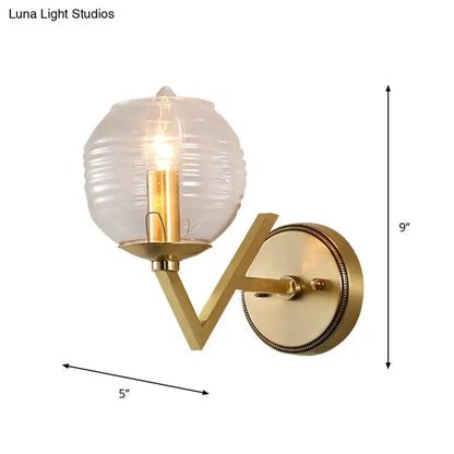 Brass ball sconce with ribbed glass shade for bedroom wall lighting 9in tall projection on Tampa Home & Garden Store