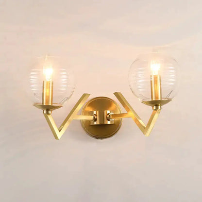 Brass double-arm ball sconce with ribbed glass shades Decorbites bedroom lighting on Tampa Home & Garden Store