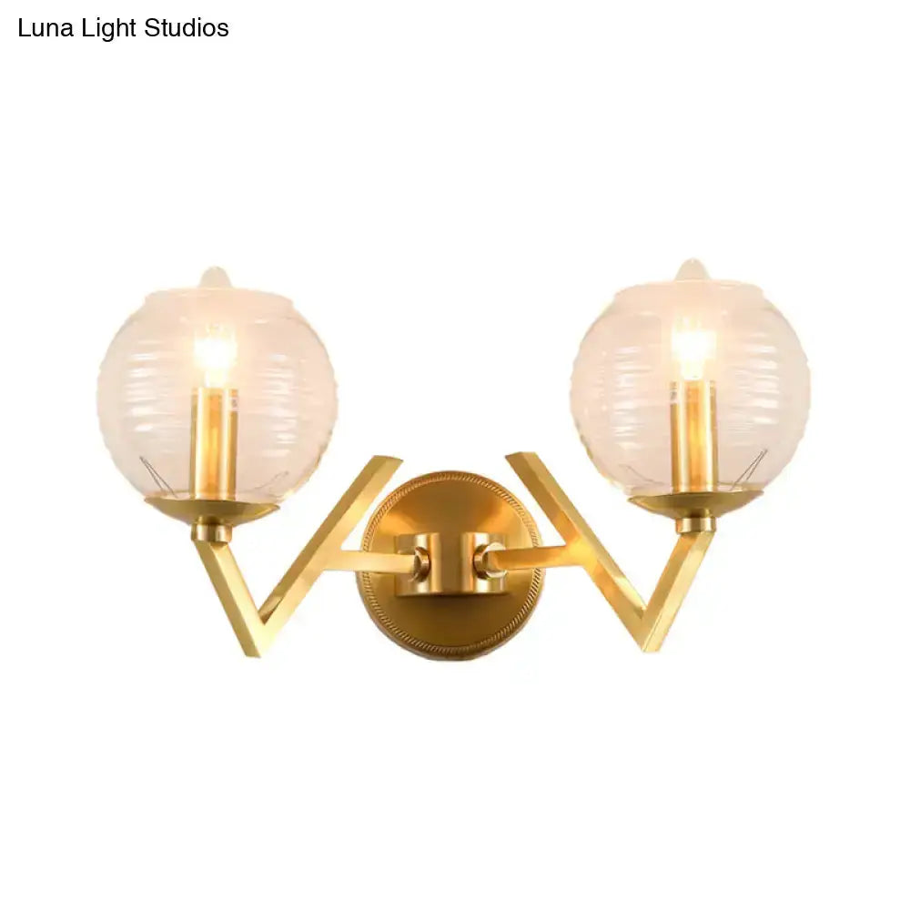 Brass twin-arm wall sconce with ribbed glass globes by Decorbites for bedroom lighting on Tampa Home & Garden Store
