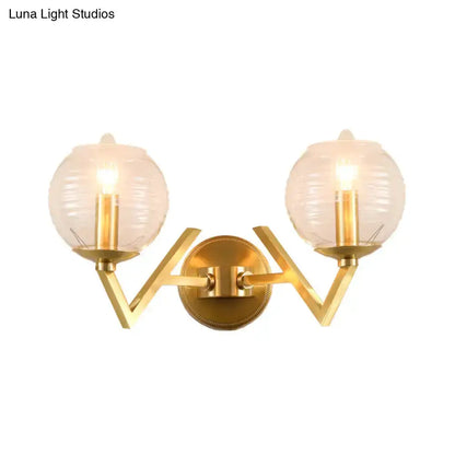 Brass twin-arm wall sconce with ribbed glass globes by Decorbites for bedroom lighting on Tampa Home & Garden Store