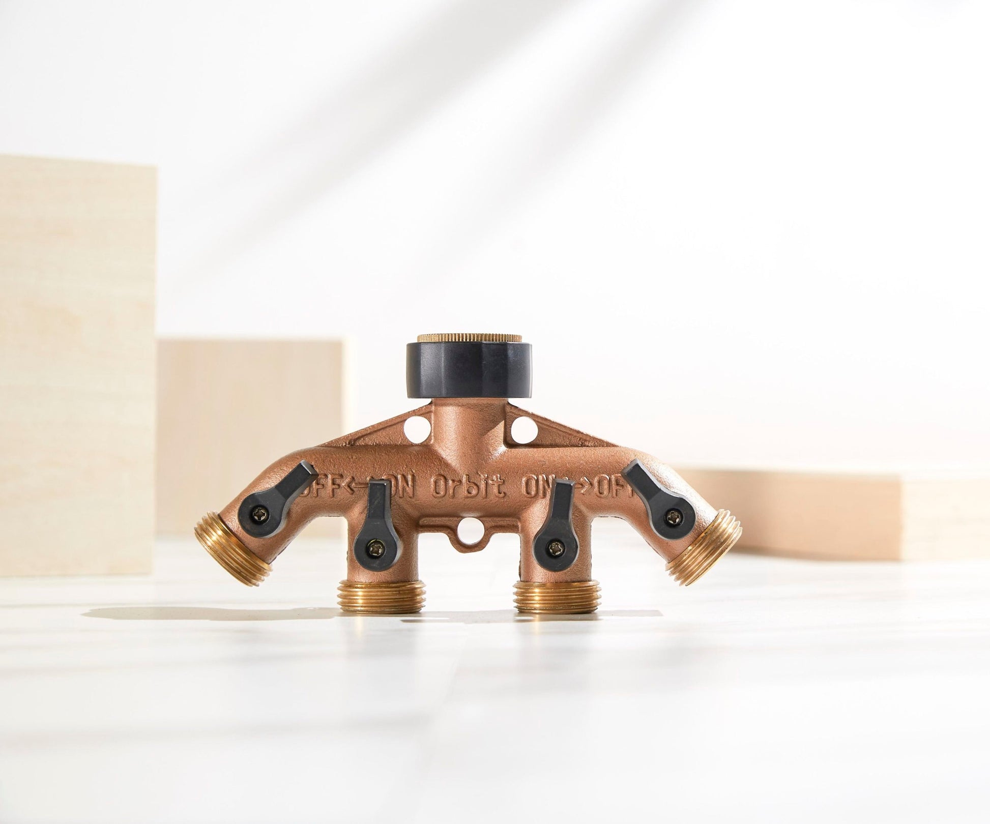 Brass hose end manifold Orbit Irrigation with four outlets and black valve handles on Tampa Home & Garden Store