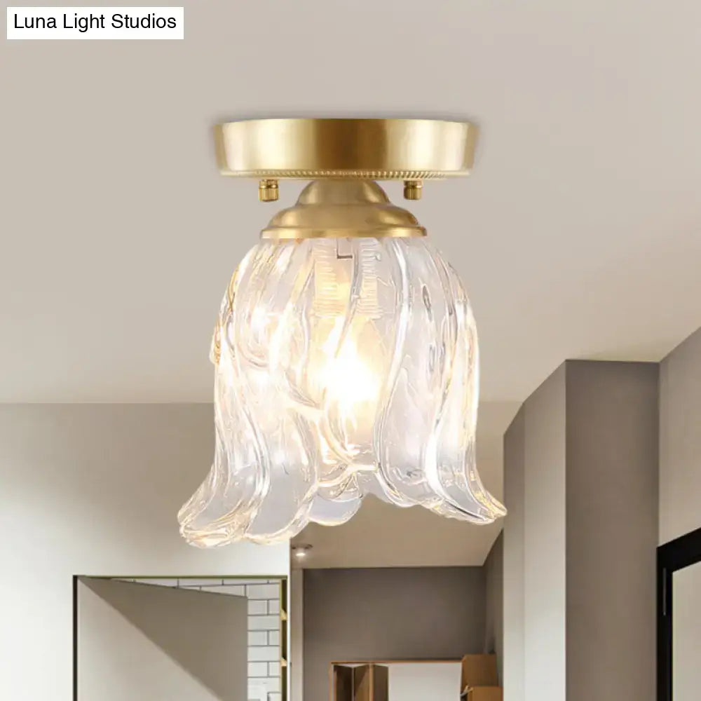 Brass glass flush mount light with a sculpted wavy clear shade by Luna Light Studios on Tampa Home & Garden Store