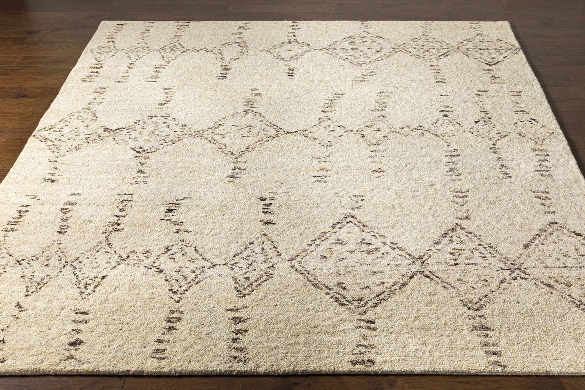 Bordertown hand-knotted wool rug beige with brown geometric diamonds on dark wood floor on Tampa Home & Garden Store