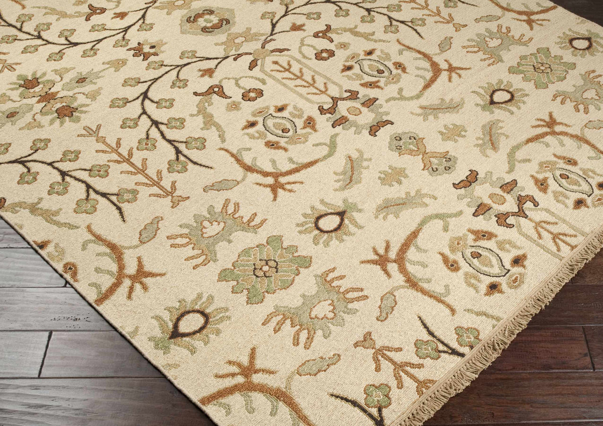 Brentford Carpet rug in beige with sage green and brown floral vine pattern, fringed edge on Tampa Home & Garden Store