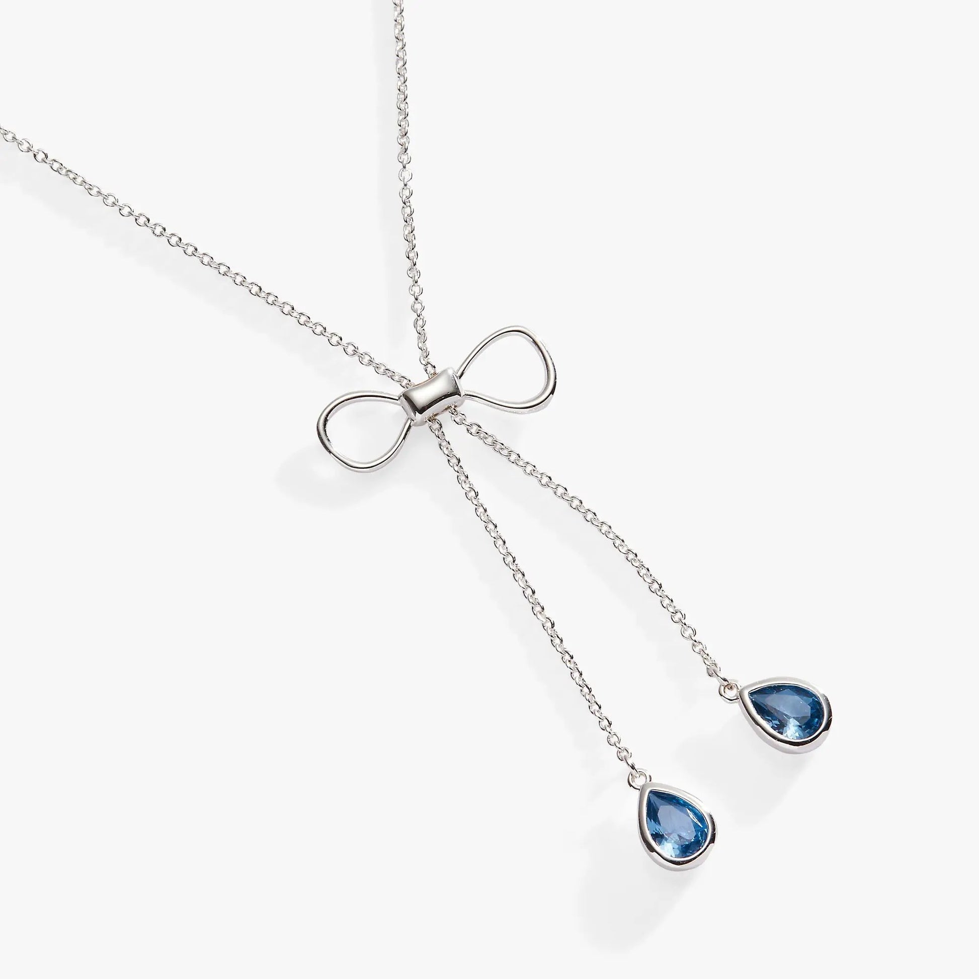 Bow adjustable slider necklace by Alex and Ani with a silver bow charm and blue teardrop pendant on Tampa Home & Garden Store
