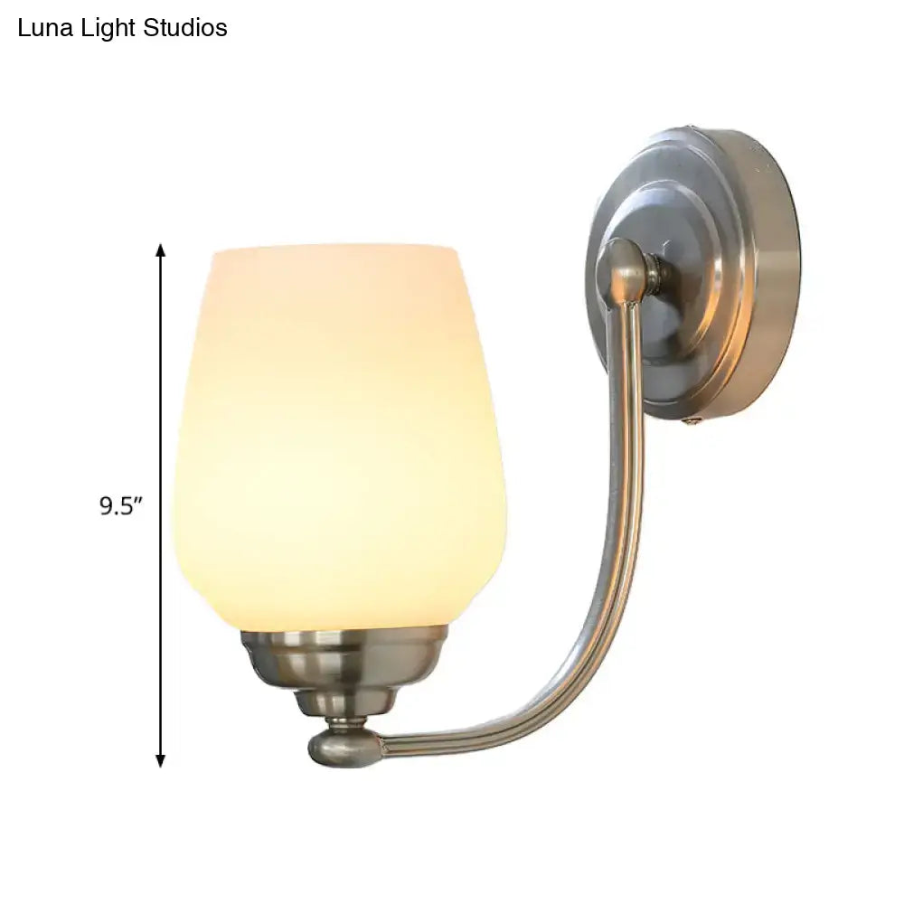 Nickel glass wall lamp by Decorbites featuring a frosted glass shade and curved arm on Tampa Home & Garden Store
