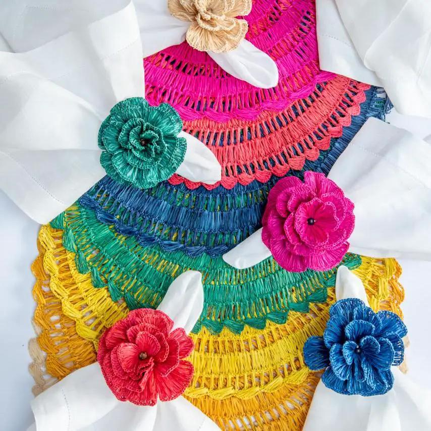 Buriti Straw Placemats by Talah Home, handcrafted rainbow stack with floral rosettes on Tampa Home & Garden Store