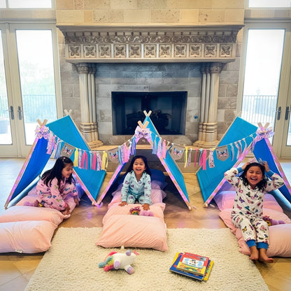 Butterfly Birthday Party Sleepover Kit: three blue tents, pink pillows, butterfly garlands; kids in pajamas at a cozy indoor campsite by the fireplace on Tampa Home & Garden Store