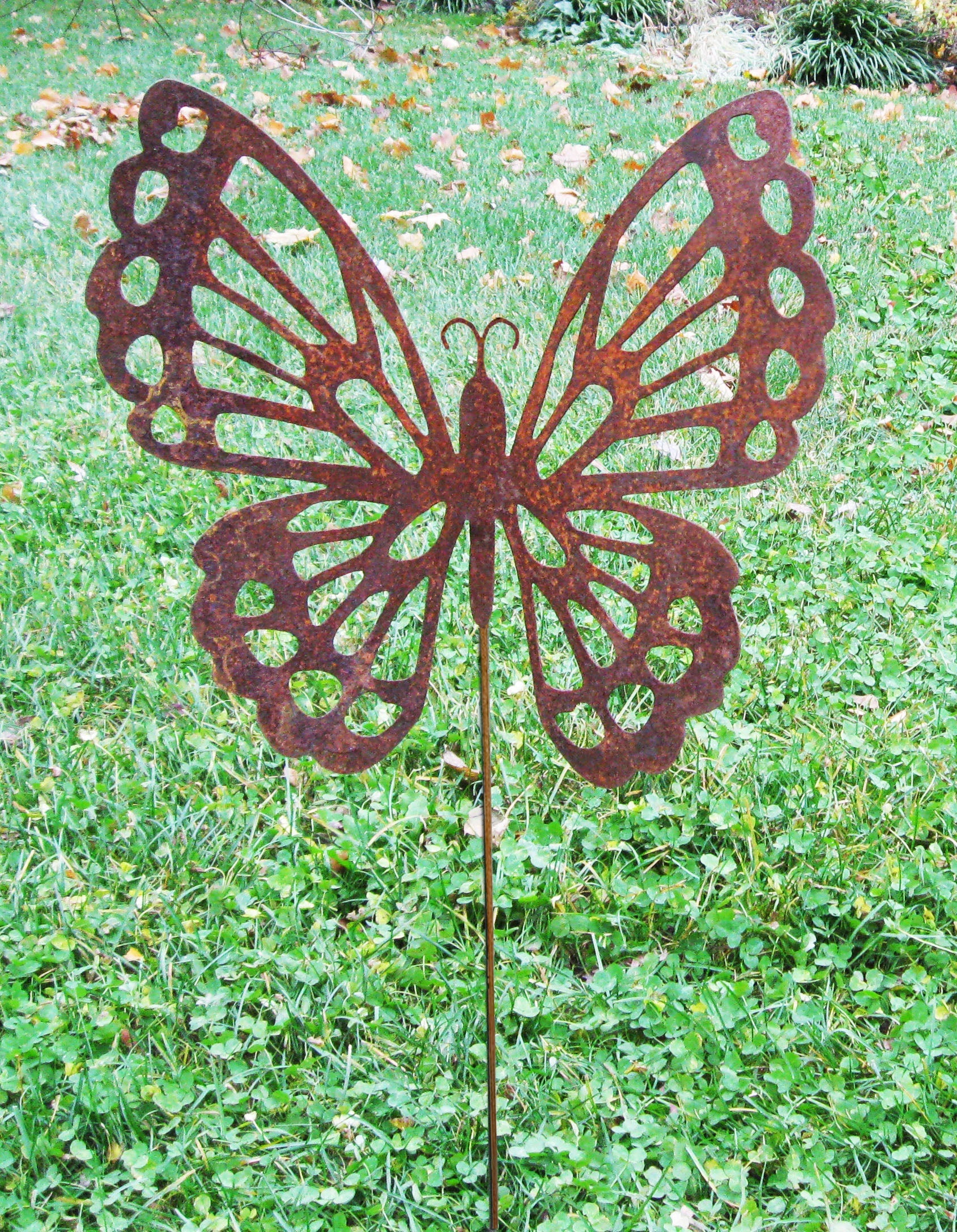 Butterfly garden stake by Rustica Ornamentals, rusted metal silhouette with cut-out wings on Tampa Home & Garden Store