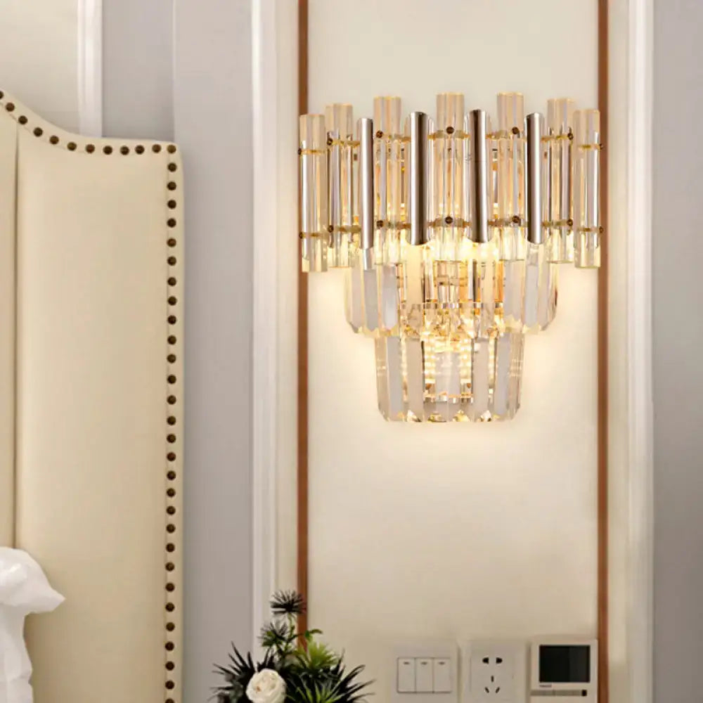 Wall sconce with gold finish and cascading crystal prisms, butterfly-inspired bedroom light on Tampa Home & Garden Store