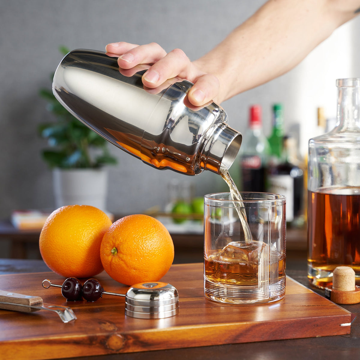 Viski Harrison Heavyweight Cocktail Shaker, stainless steel pouring amber into a rocks glass on Tampa Home & Garden Store