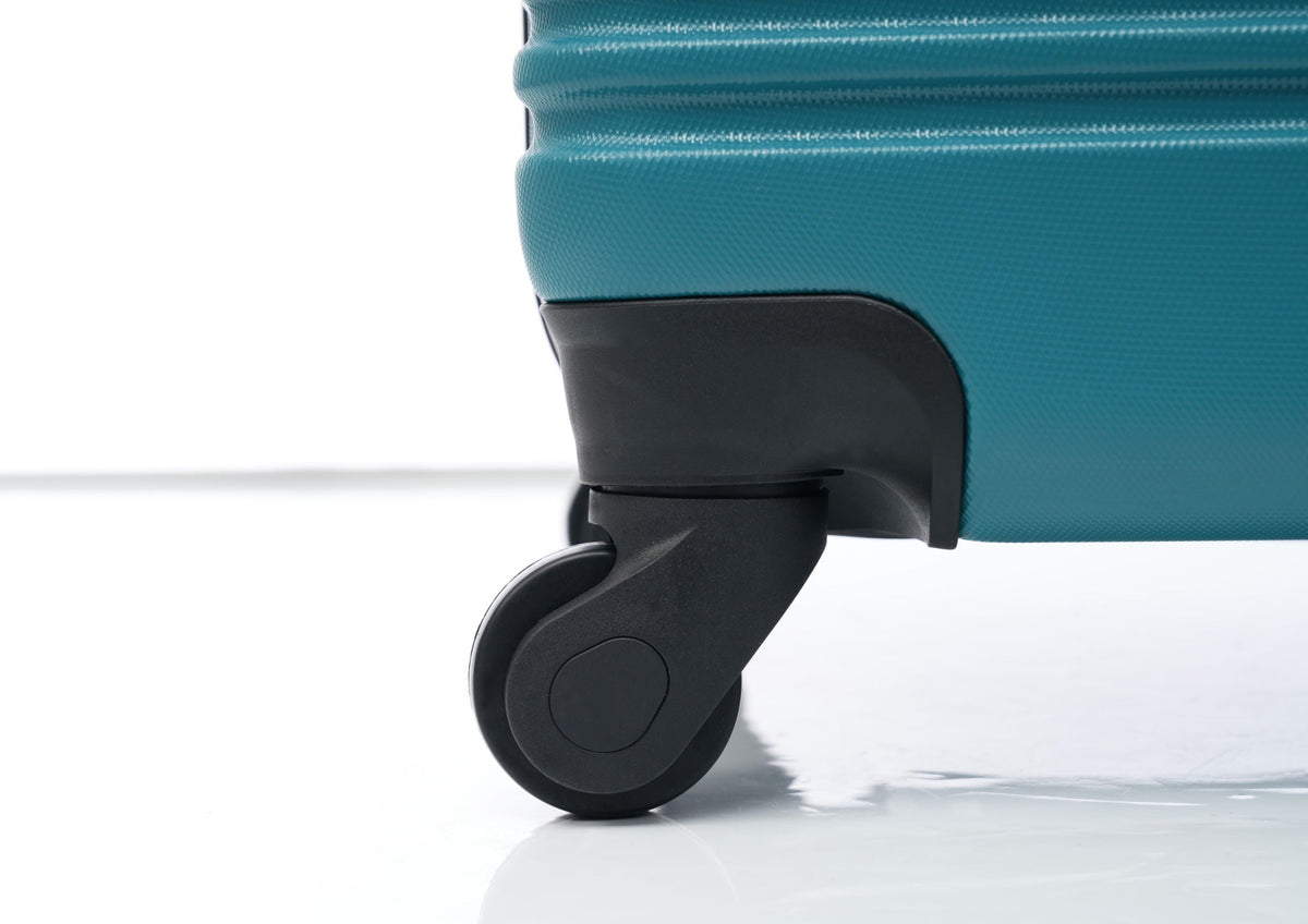Hardshell luggage closeup teal with black spinner wheel on Tampa Home & Garden Store