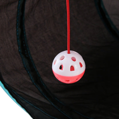 Cat toy ball pink and white hanging from a red string inside a black collapsible tunnel tent on Tampa Home & Garden Store