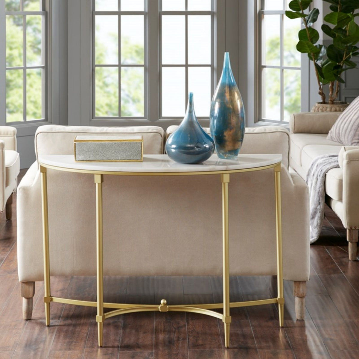 White marble console table with gold metal legs Bordeaux by HouseOfZazla in a bright living room on Tampa Home & Garden Store