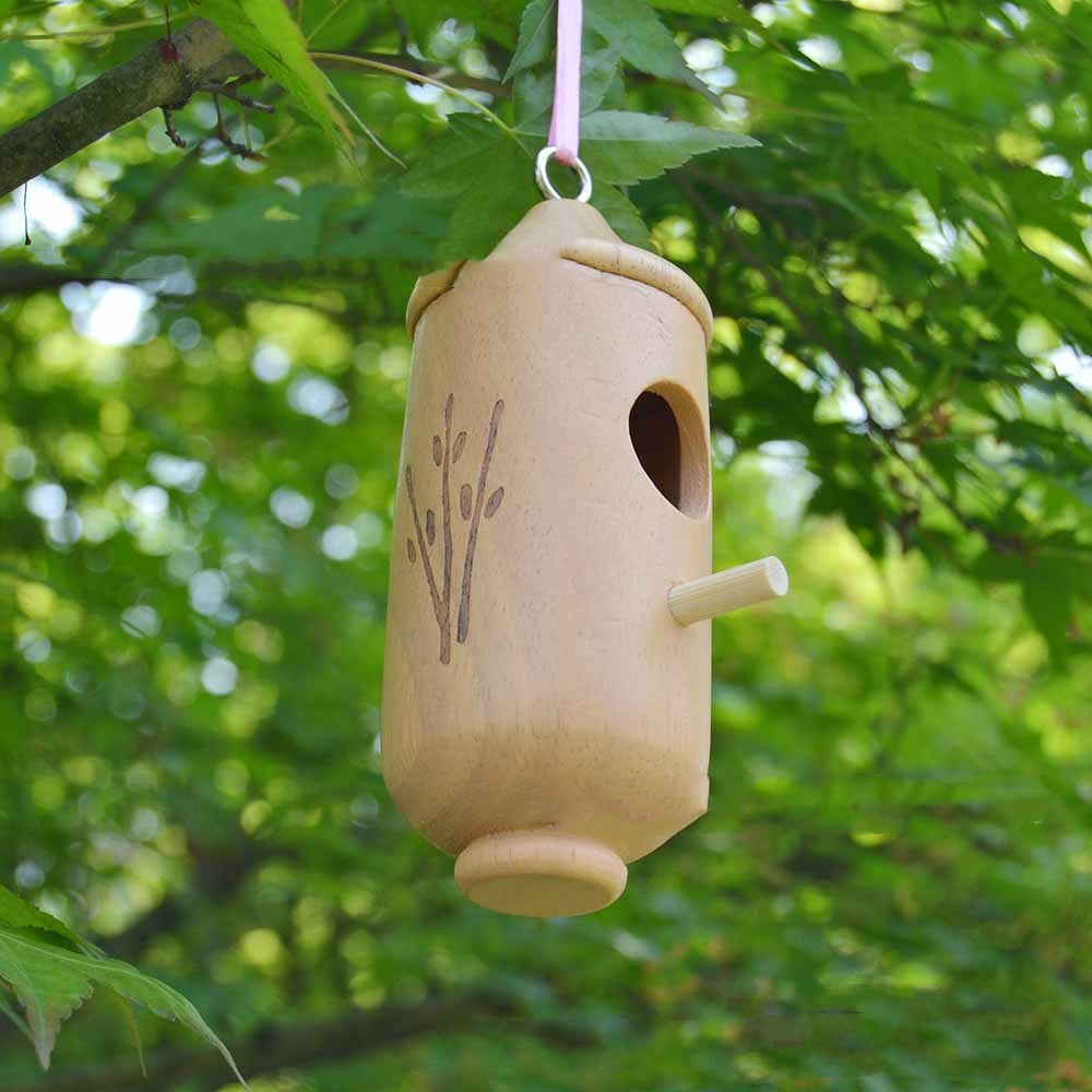 Wooden hummingbird hanging nest house with a small perch, natural wood finish and carved branch on Tampa Home & Garden Store