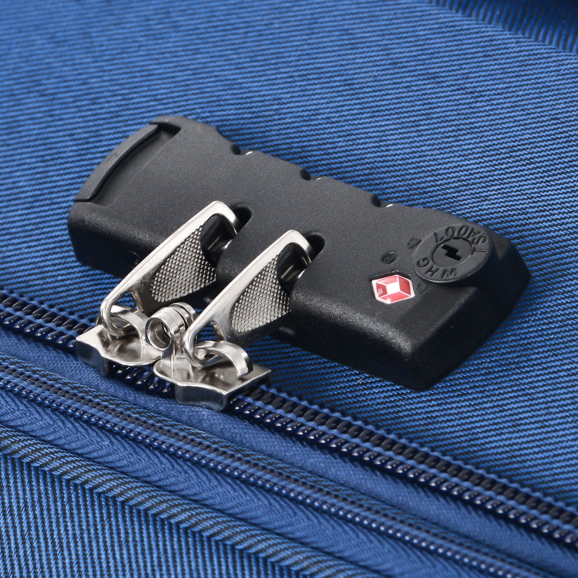 Luggage lock buckle close-up on blue fabric with metal clasps SwissGear logo on Tampa Home & Garden Store