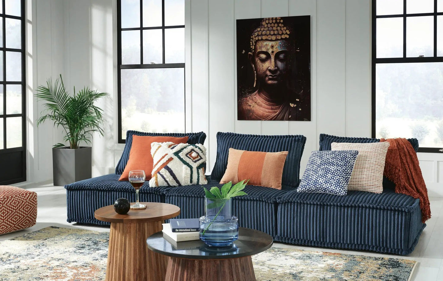 Bales sectional sofa in navy corduroy with orange and geometric pillows on Tampa Home & Garden Store