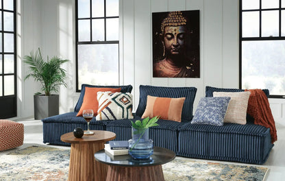 Bales sectional sofa in navy corduroy with orange and geometric pillows on Tampa Home & Garden Store