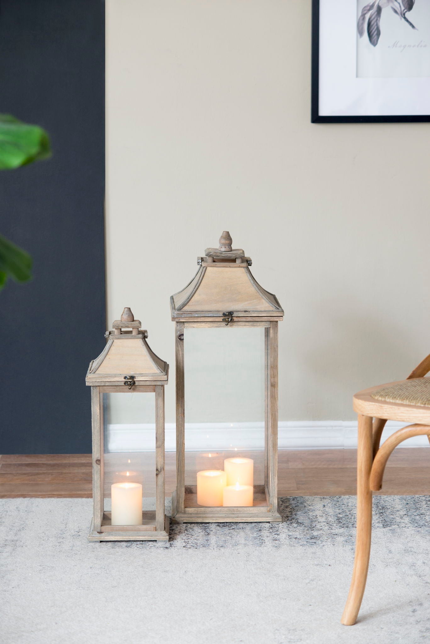 Candle lanterns ivory with glass panels and wood frames, lit for indoor outdoor decor on Tampa Home & Garden Store