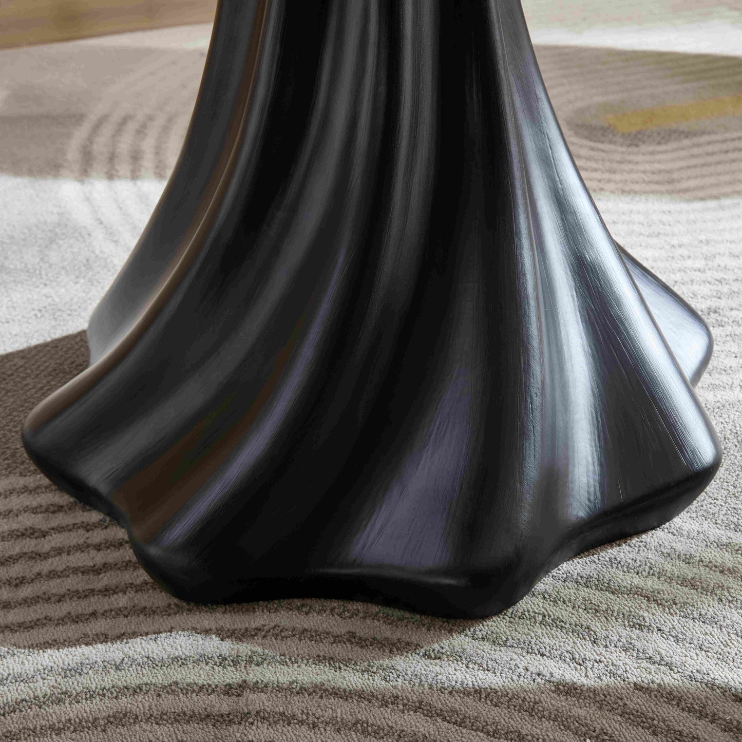 Sculptural round dining table base in black with petal shape and root texture on Tampa Home & Garden Store