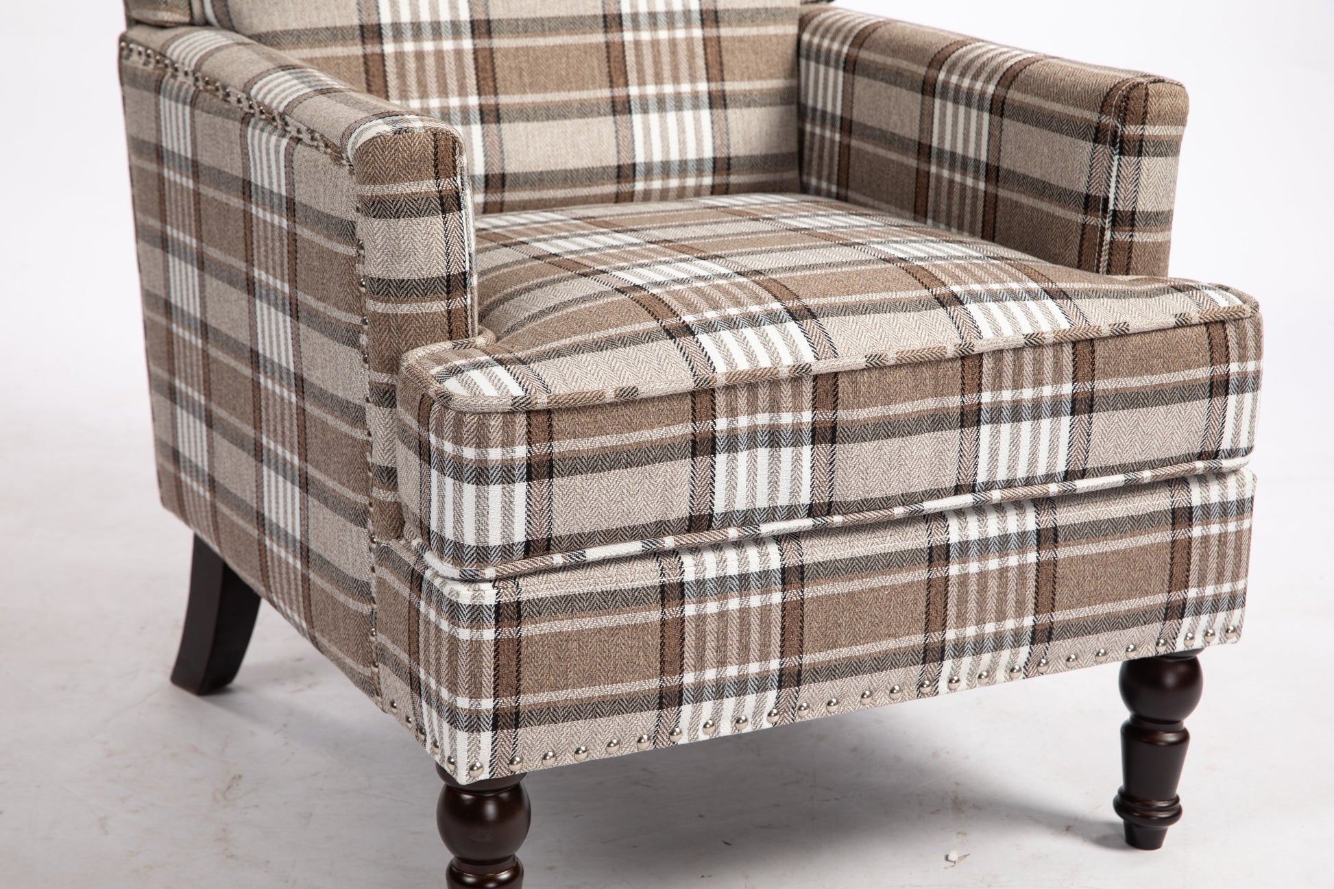 Upholstered accent chair in brown plaid linen fabric with nailhead trim and dark wood legs on Tampa Home & Garden Store